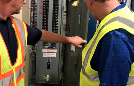 Two Workers by a Circuit Board